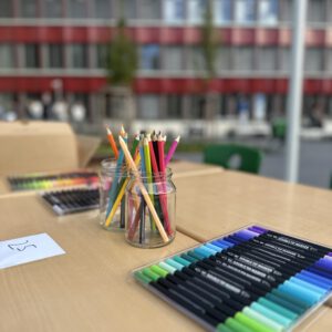 Stifte vor dem Hintergrund des Schulhauses